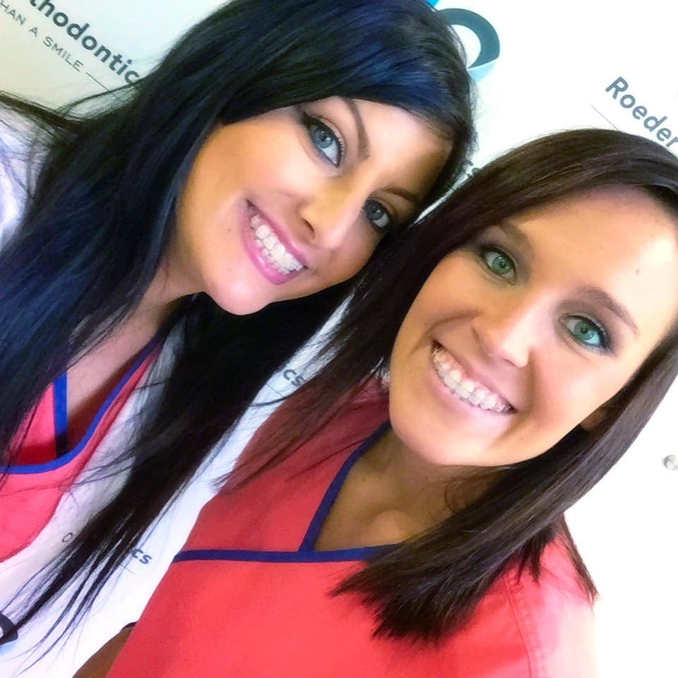a picture of two women wearing damon braces